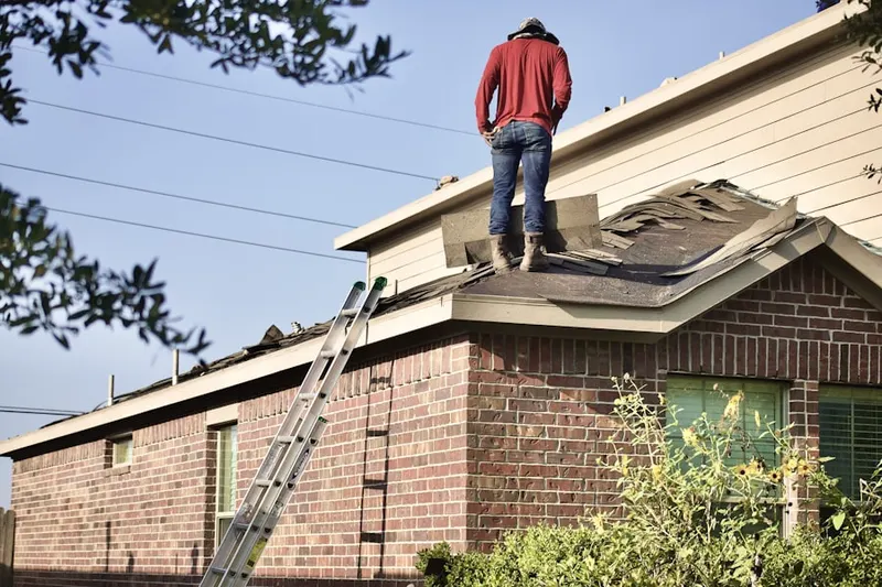 Professional roofer working on a residential roof in Englishtown